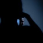 Screen Protectors - Silhouette of Man with Phone in the Dark