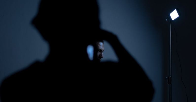 Screen Protectors - Silhouette of Man with Phone in the Dark