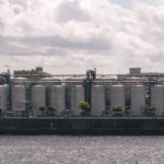 Factory Reset - A large industrial building sitting on the water