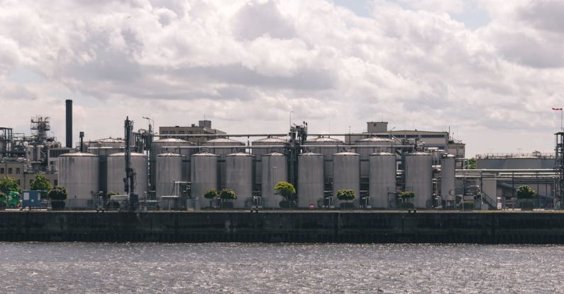 Factory Reset - A large industrial building sitting on the water