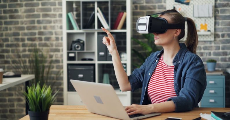 VR Displays - A woman wearing a virtual reality headset sitting at a desk