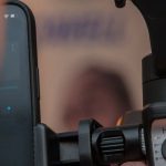 5G Technology - A person holding a smartphone and a video camera