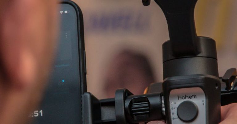 5G Technology - A person holding a smartphone and a video camera