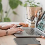 Professional Displays - Woman working retouching photo on laptop at convenient workplace