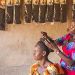 Streaming Services - A woman is getting her hair done in a shop