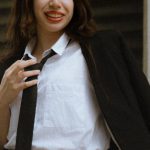 Mini-LEDs - A woman in a skirt and blazer posing for a photo