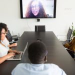 Smart TV Apps - Diverse coworkers having online conference in modern office