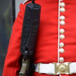 Security Concerns - A man in a red uniform holding a gun
