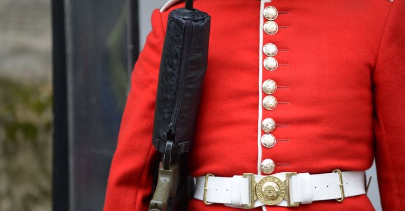 Security Concerns - A man in a red uniform holding a gun