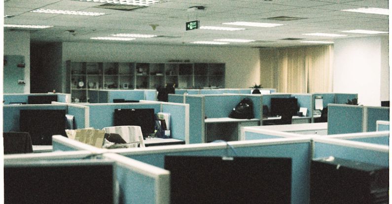 Curved Monitors - An empty office with cubicles and desks