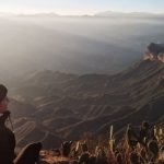 AMOLED - A Person Sitting at the Mirador Cuatro Palos