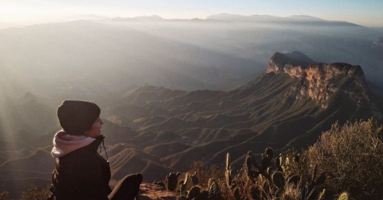 AMOLED - A Person Sitting at the Mirador Cuatro Palos