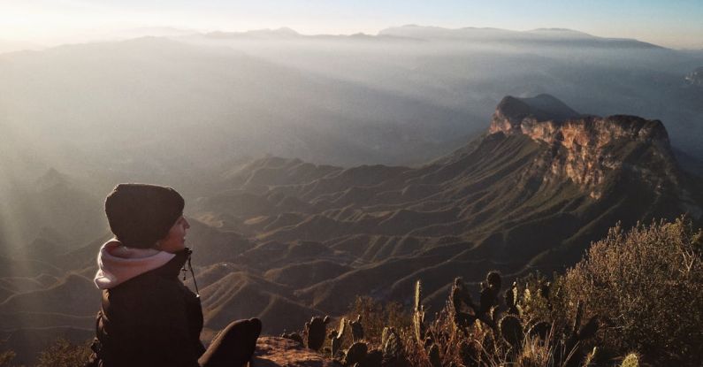 AMOLED - A Person Sitting at the Mirador Cuatro Palos