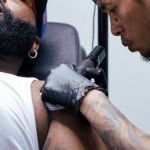 E-Ink - A man getting a tattoo on his arm