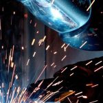 Manufacturing - Person in Welding Mask While Welding a Metal Bar