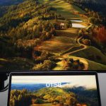 Rollable Screens - A laptop and monitor on a desk with a mountain view