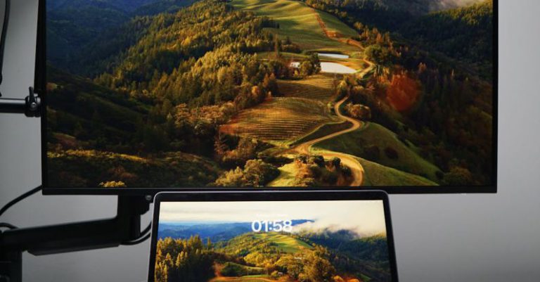 Rollable Screens - A laptop and monitor on a desk with a mountain view