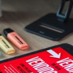 Portability - A book on a desk with a computer and keyboard