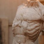 Durability - White Concrete Statue of Man Under the Light Bulb