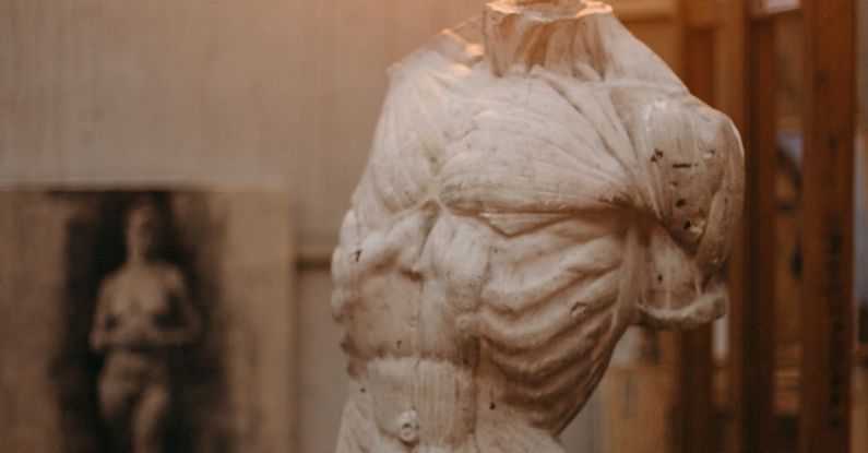 Durability - White Concrete Statue of Man Under the Light Bulb