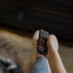 Screen Cleaning - Person Holding Black and Silver Remote Control